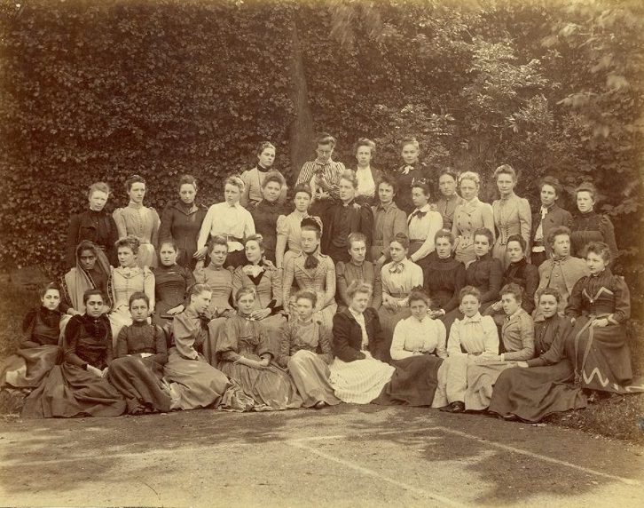 Sepia group photograph of female tutors and students at Somerville College, University of Oxford, 1891. Indian lawyer and activist Cornelia Sorabji is pictured in the middle row, far left. The women wear Victorian style dress.