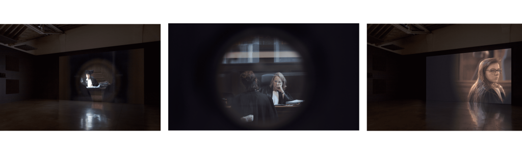 Three images side by side. In the first, a film installation in a dark space showing a female judge. The second is a scene from a courtroom seen through a circular window. A seated judge with light short hair wearing a black robe and a white collar is opposite a second female judge with brown hair. The third image is a female judge with long auburn hair and glasses, looking back at the camera.