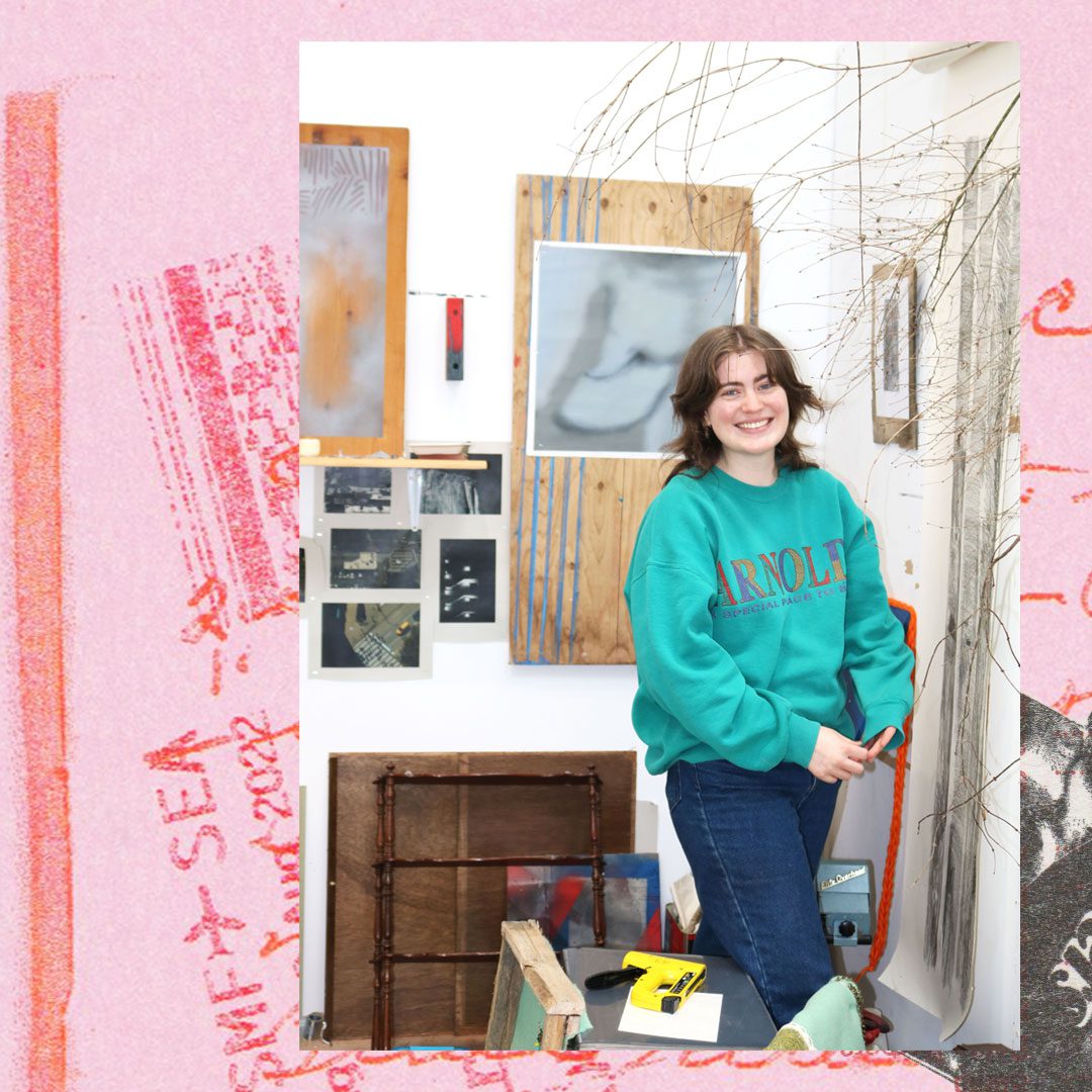 A person in a bright turquoise jumper is smiling at the camera. The photo is collaged onto a pink background.