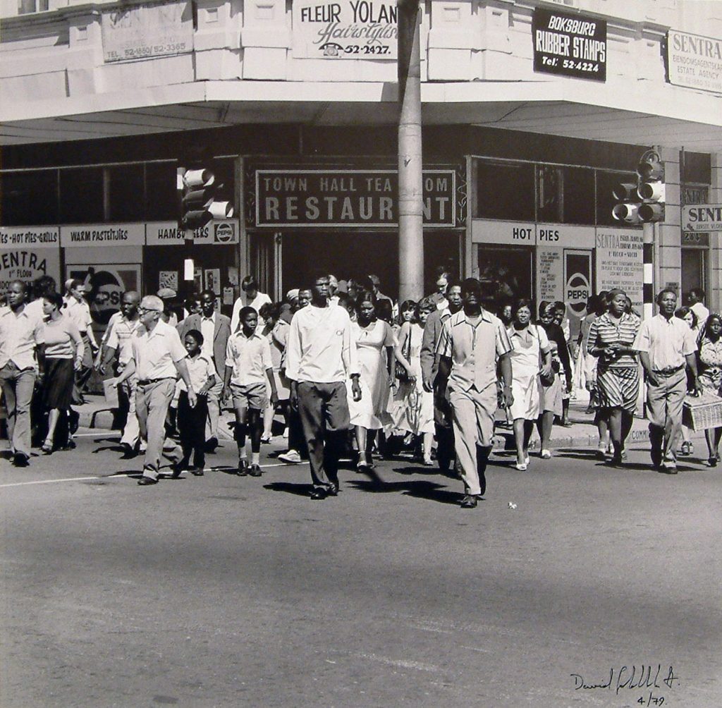 Limited Edition print of a black and white photograph by David Goldblatt showing a large group of people crossing a road.