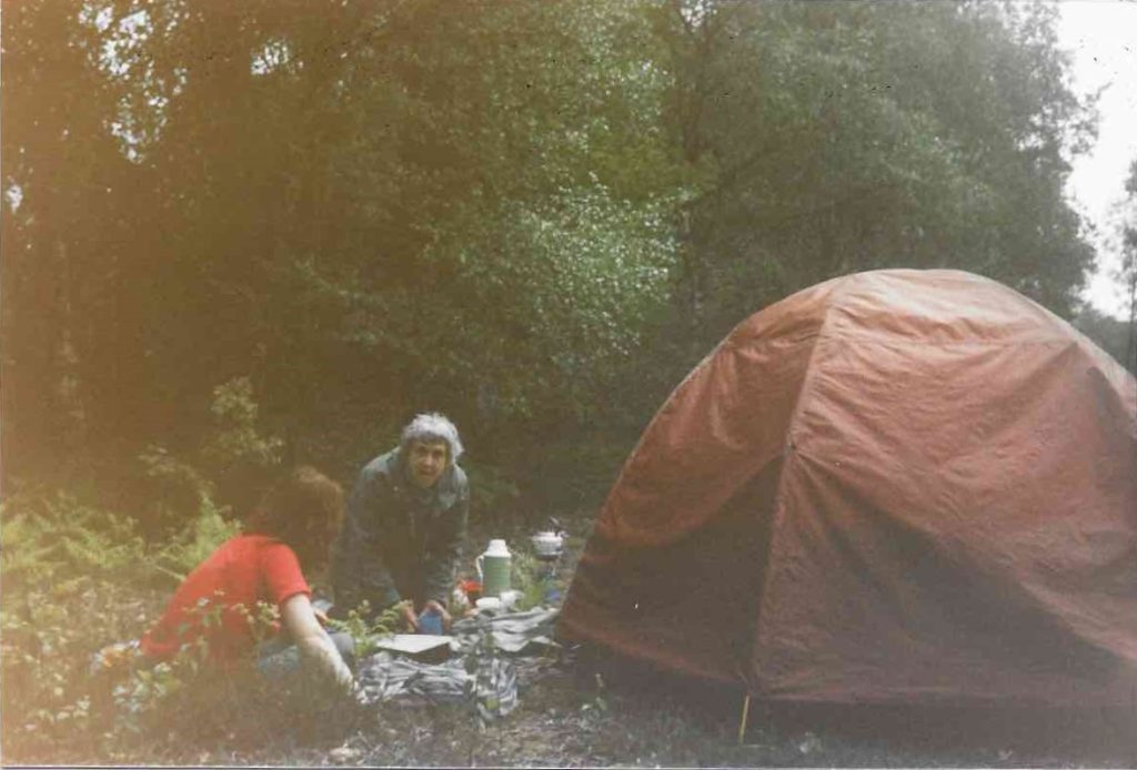 Two women sit outside a tent at Green Gate in Greenham Common Women's Peace Camp.