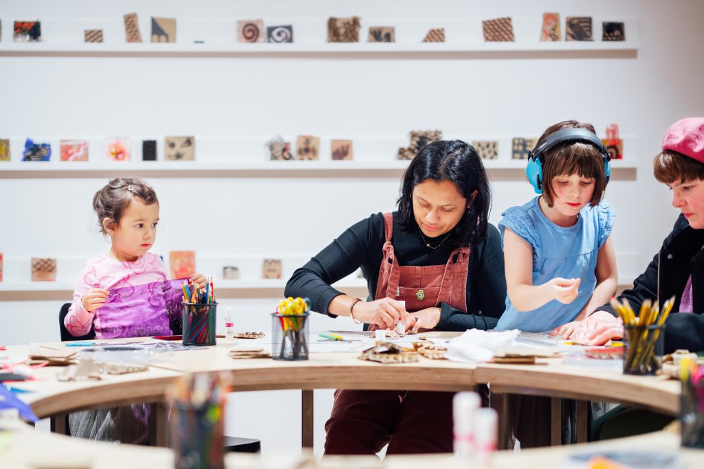 Two children and two women are taking part in a workshop in Modern Art Oxford's Studio.