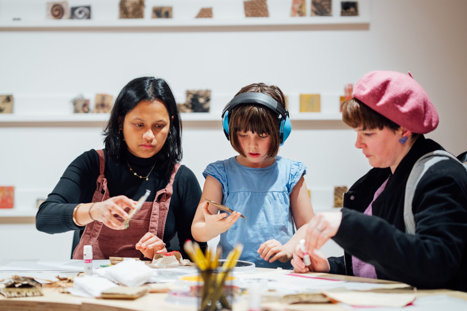 A family craft together at a table.