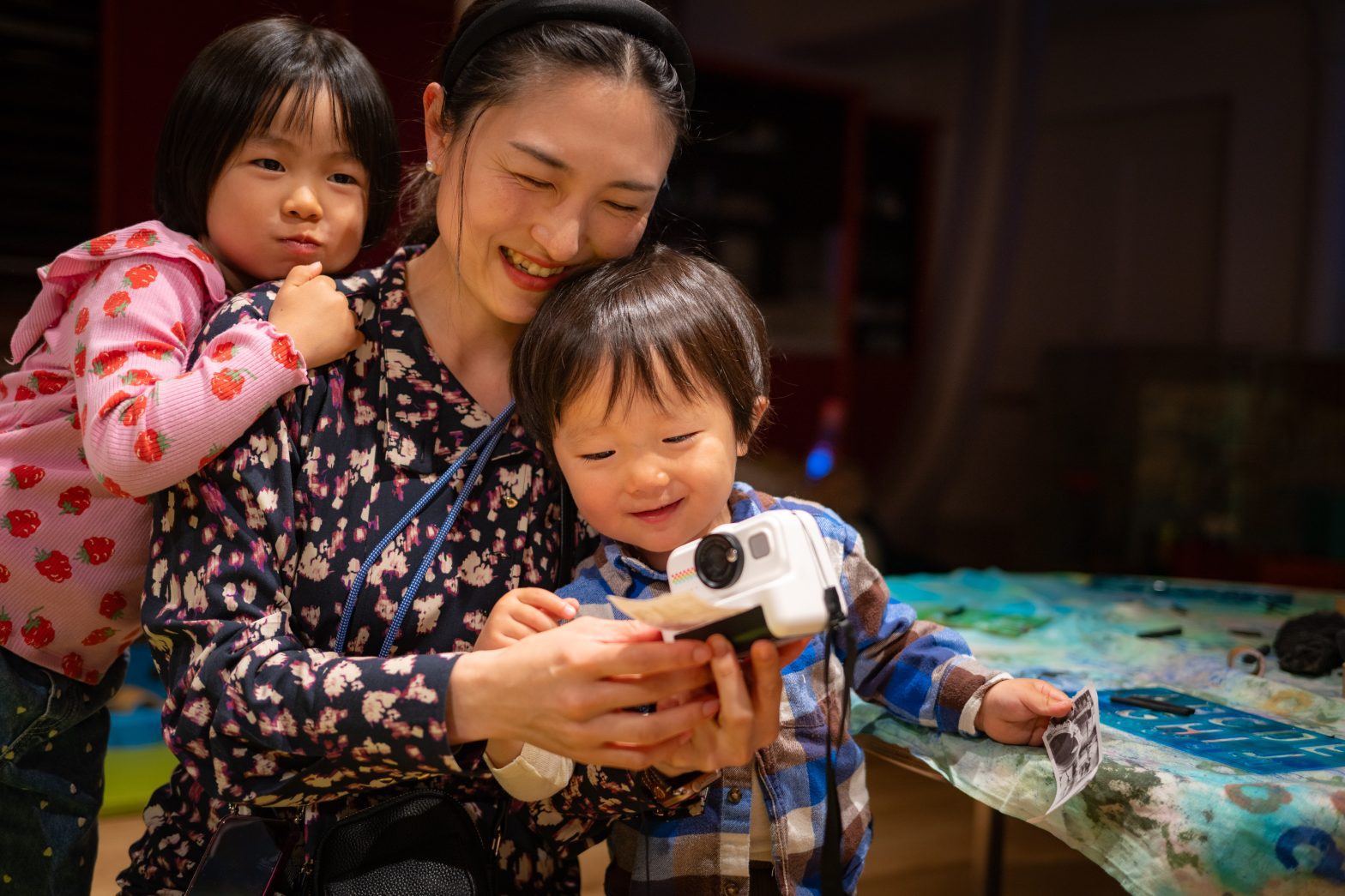A mother and children take a photograph together.