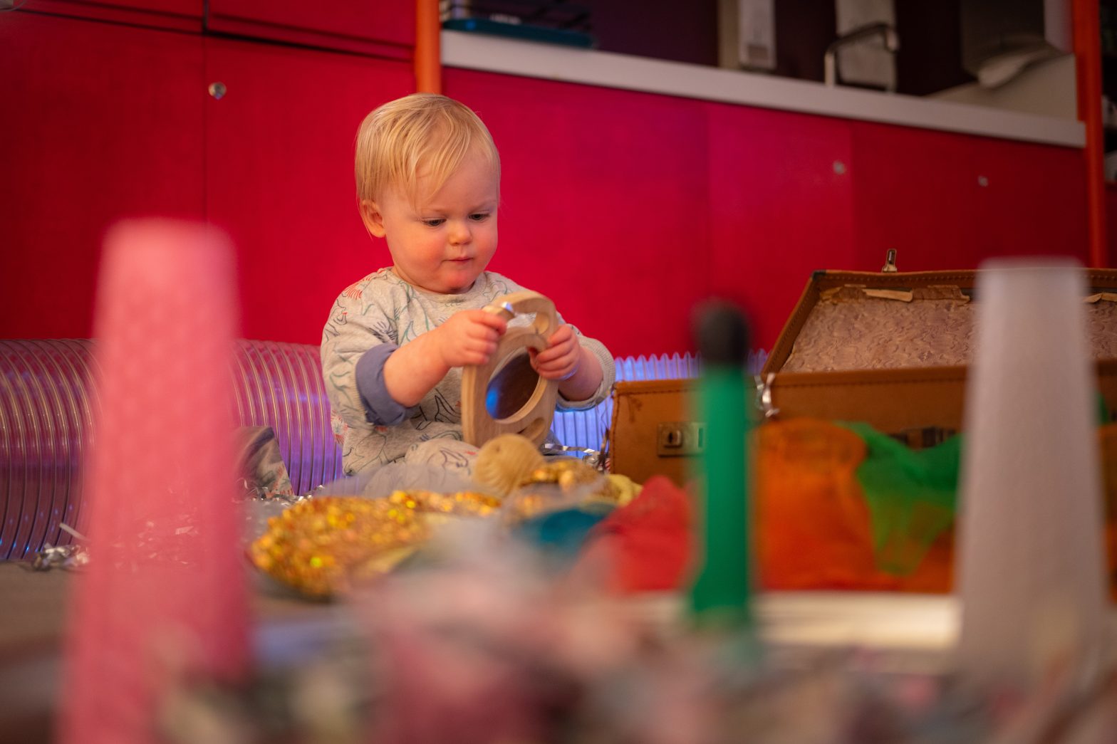 A child plays with wooden blocks in a sensory play session at Modern Art Oxford.