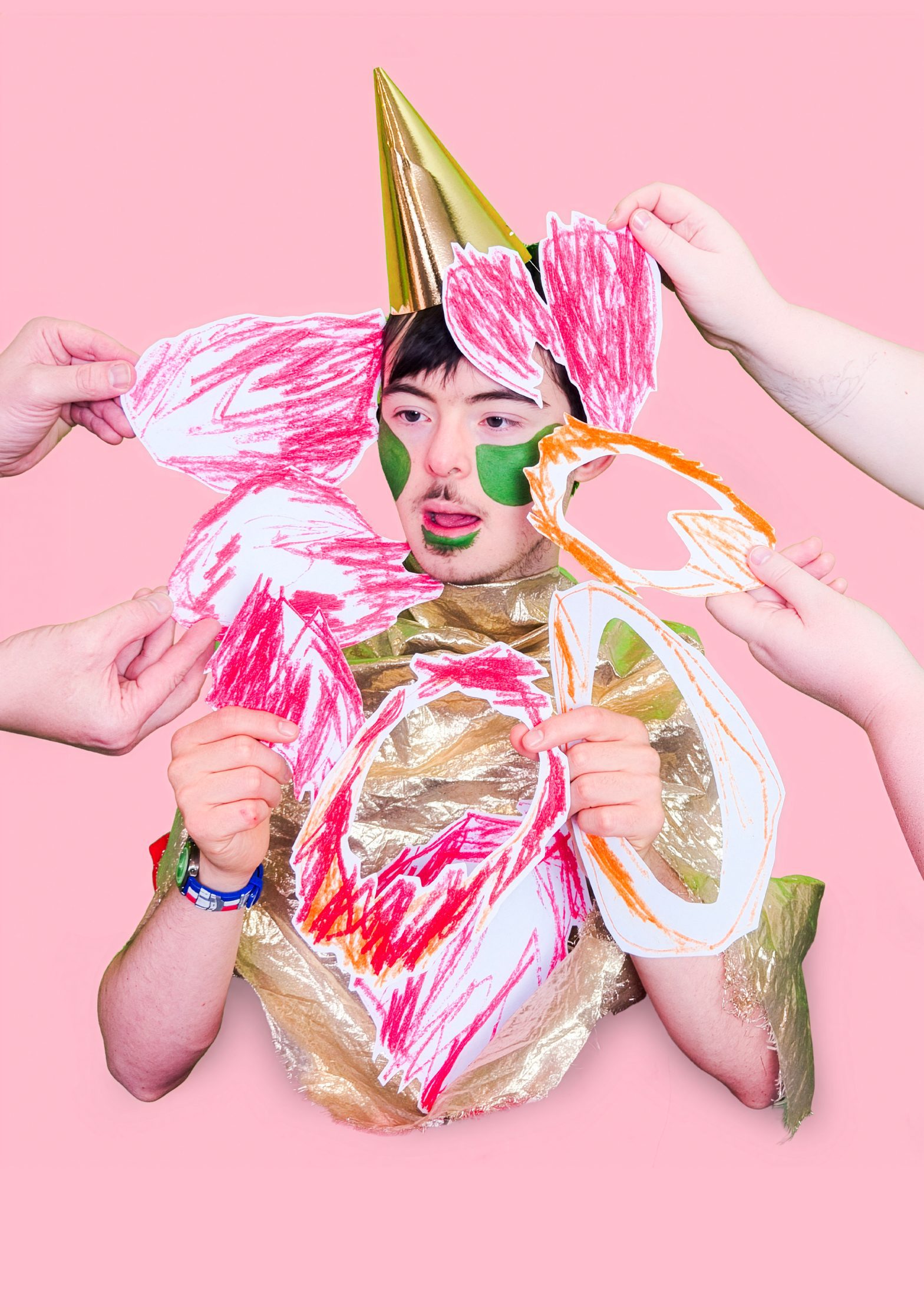 A photo of someone with collaged drawings stuck all over their body.