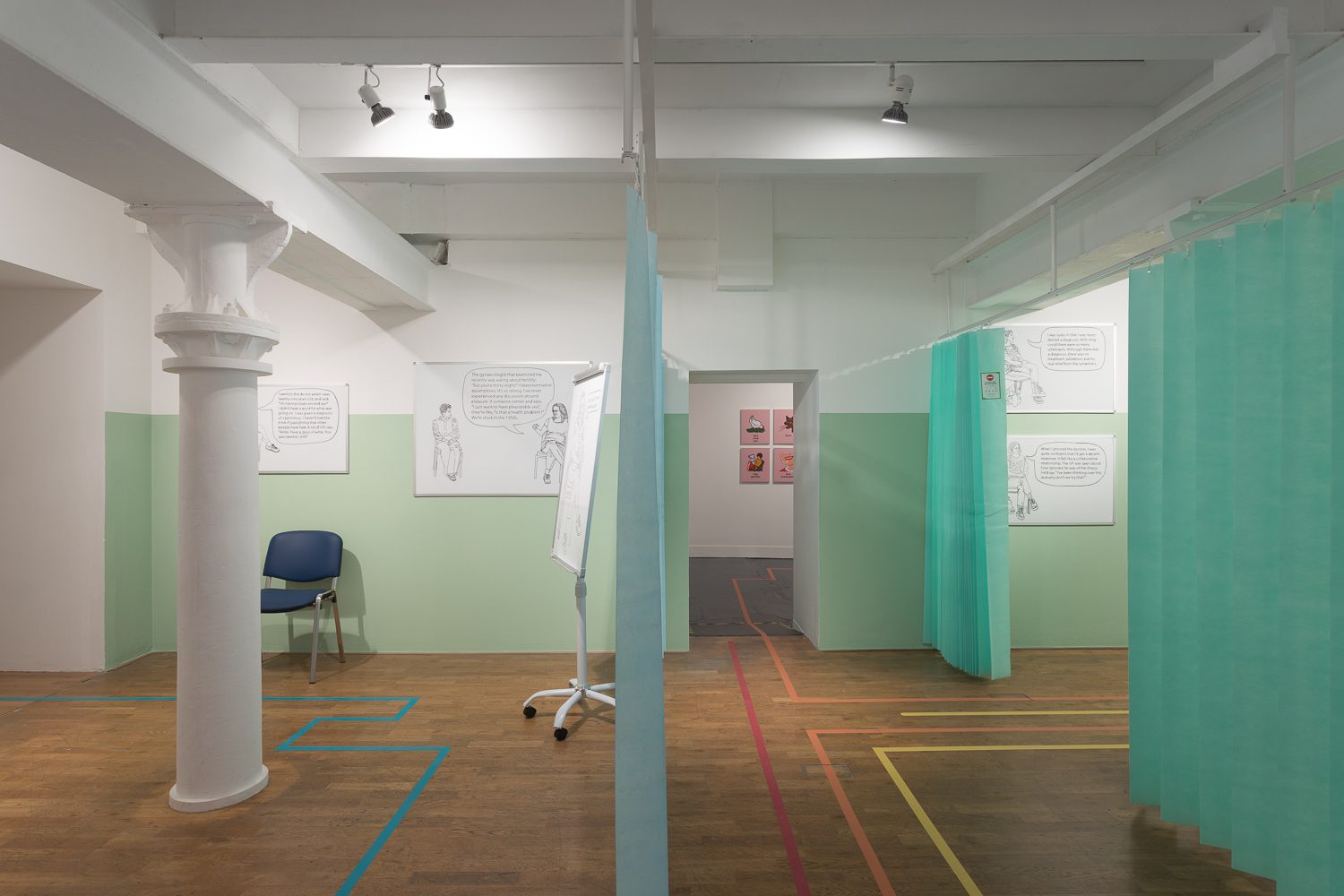 A photo of an installation by Olivia Plender in her exhibition at Modern Art Oxford. It shows a gallery set up like a hospital room.